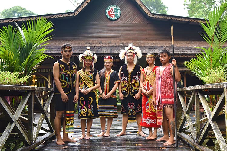 Men and Woman in Borneo's traditional attire at Sukau Rainforest Lodge